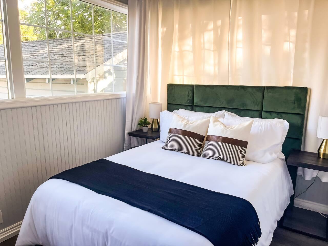 Third bedroom with a green upholstered headboard