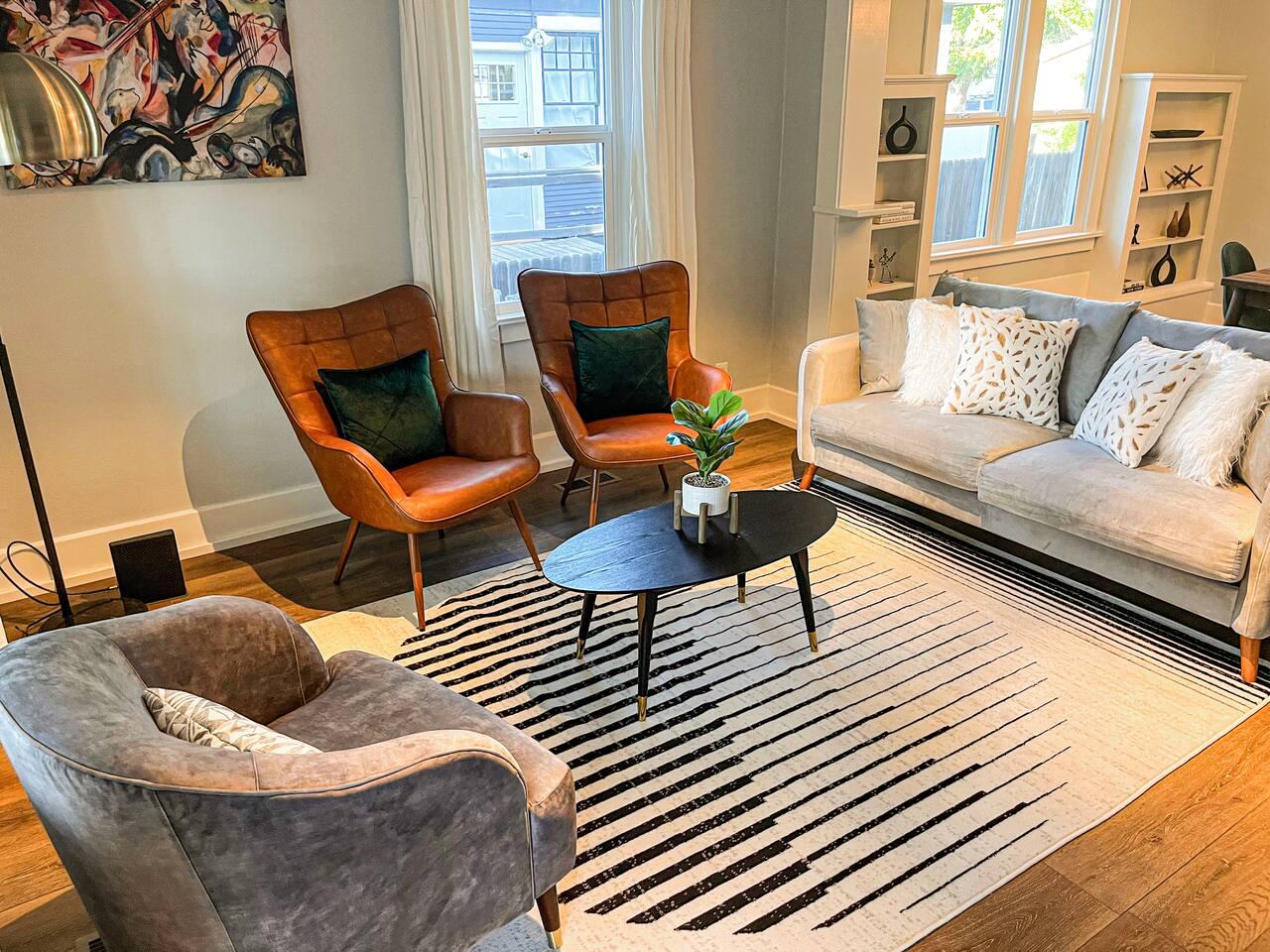 Living room seating with leather accent chairs and a sofa