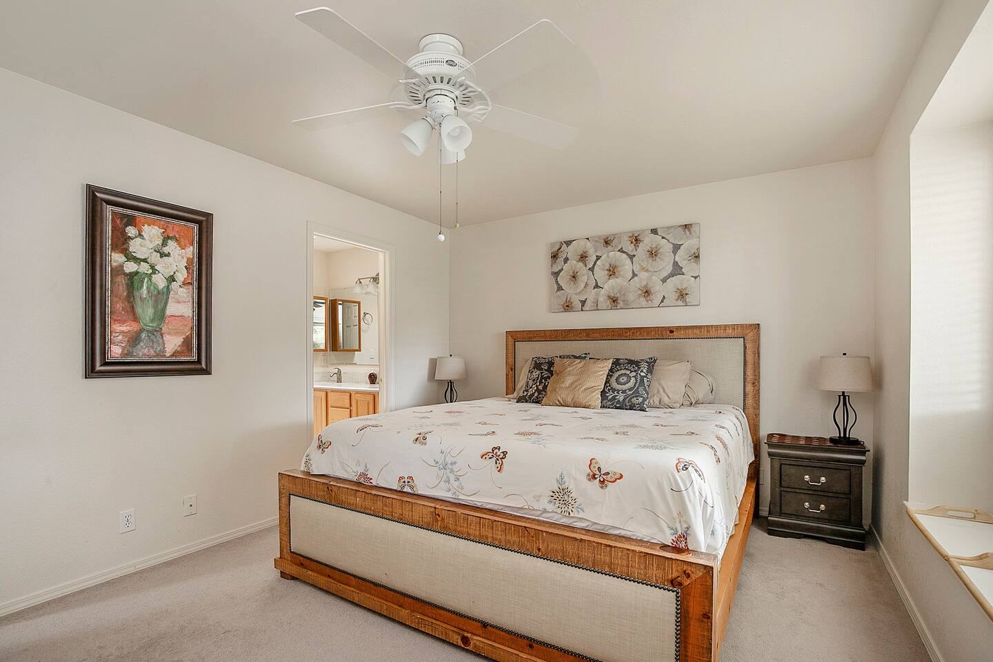 Primary bedroom with a king bed and ceiling fan