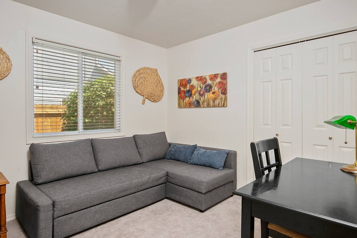 Third bedroom with a sleeper sectional and a desk