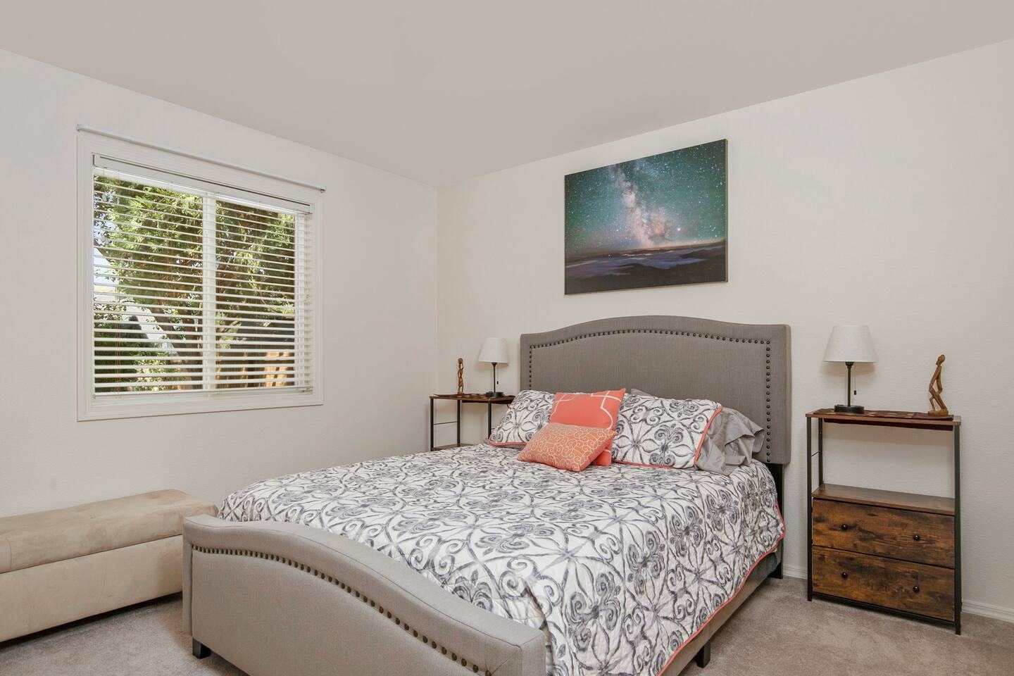 Queen bedroom with an upholstered headboard and nightstands