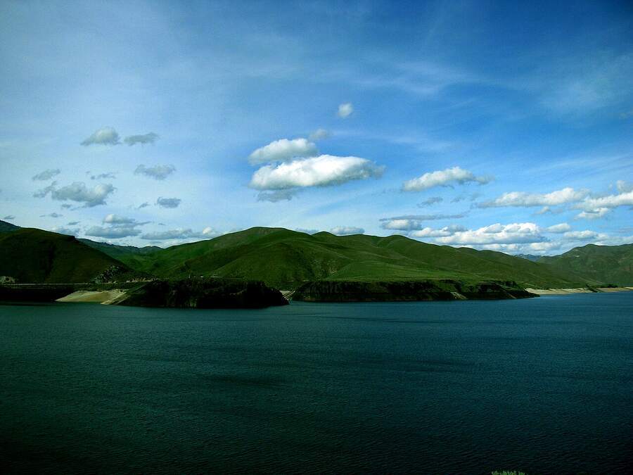 Lucky Peak Reservoir with green hills under a blue sky