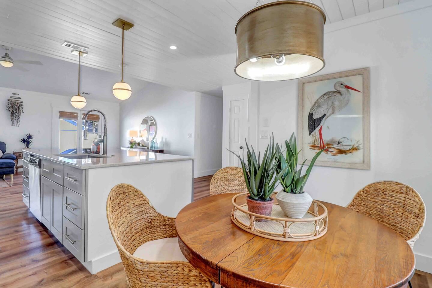 Round dining table under a brass pendant light