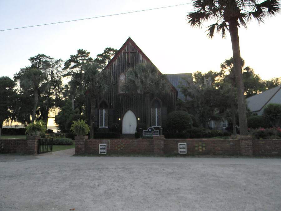 The Church of the Cross in Old Town Bluffton, framed by palmettos