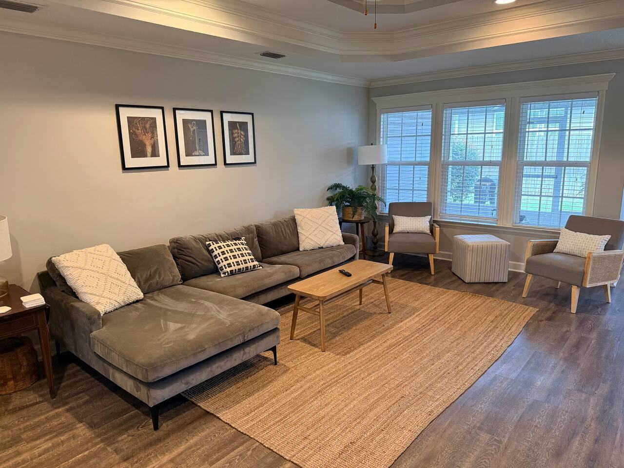 Living room seating area with gray sectional and armchairs