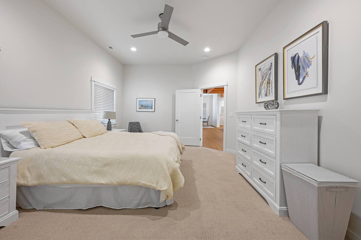King primary bedroom with white dresser