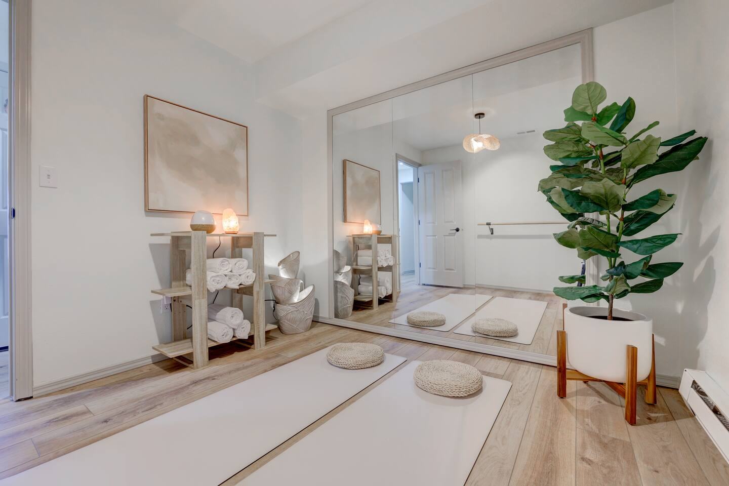 Yoga studio with mirror wall, ballet barre and mats