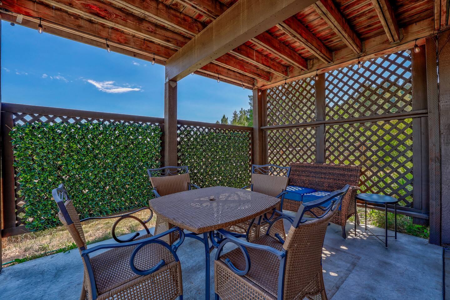 Furnished covered patio with table and chairs