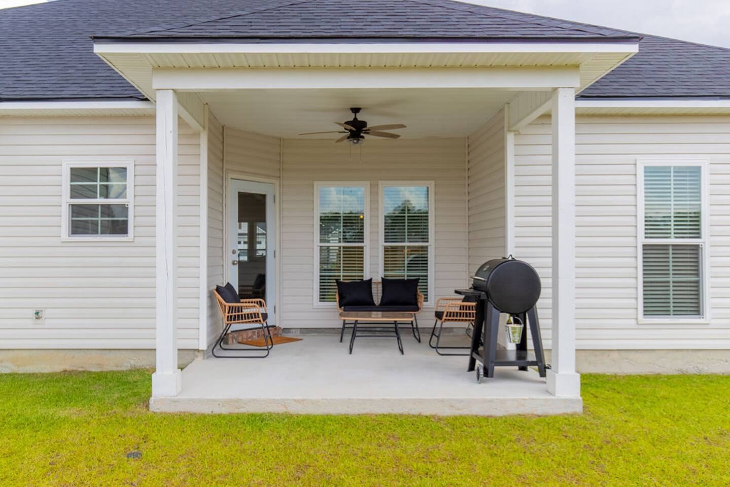 Back of the house with covered patio, ceiling fan and smoker