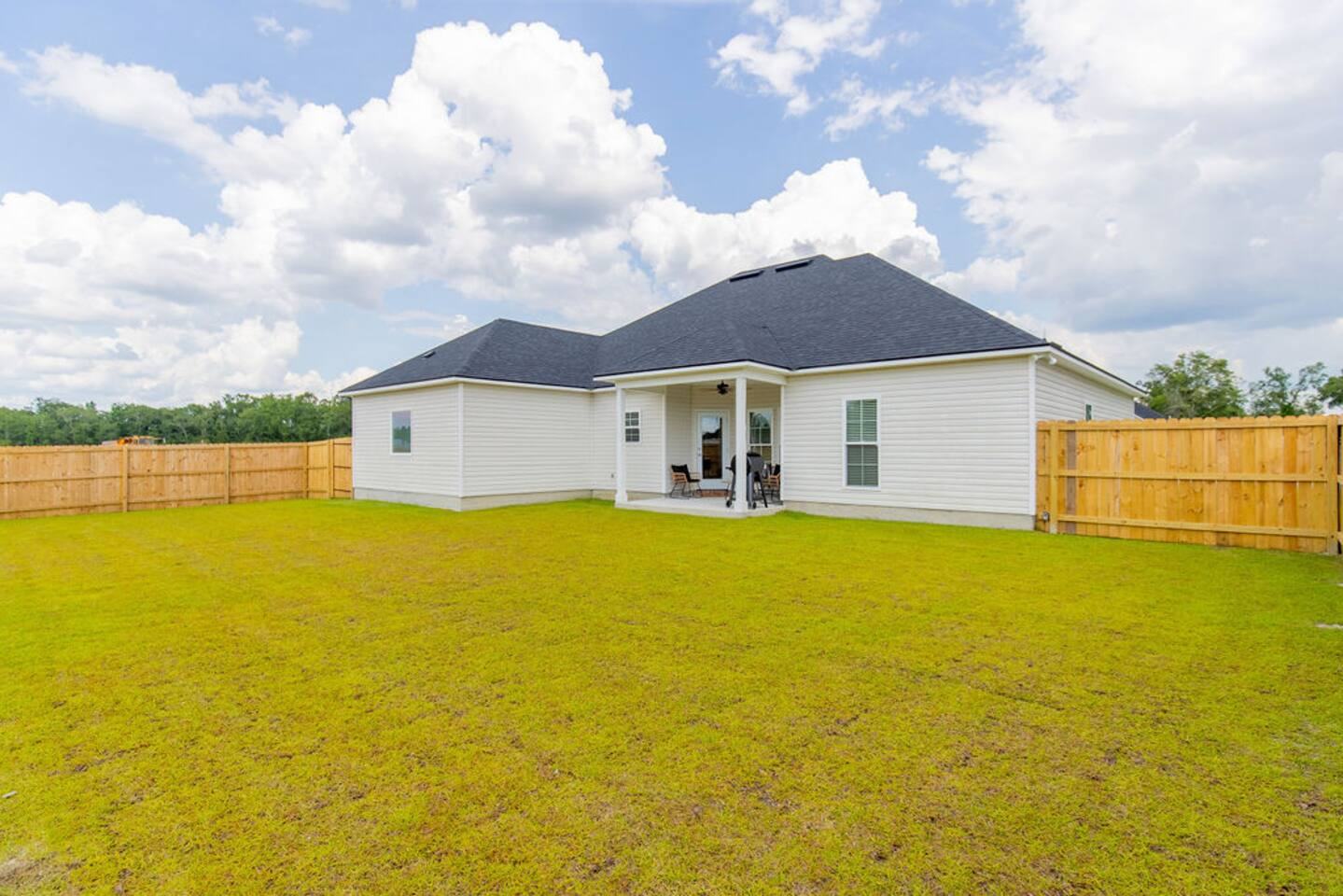 Fenced backyard and rear of the single-level home