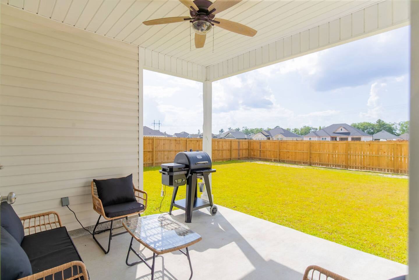 View from the covered patio over the fenced backyard