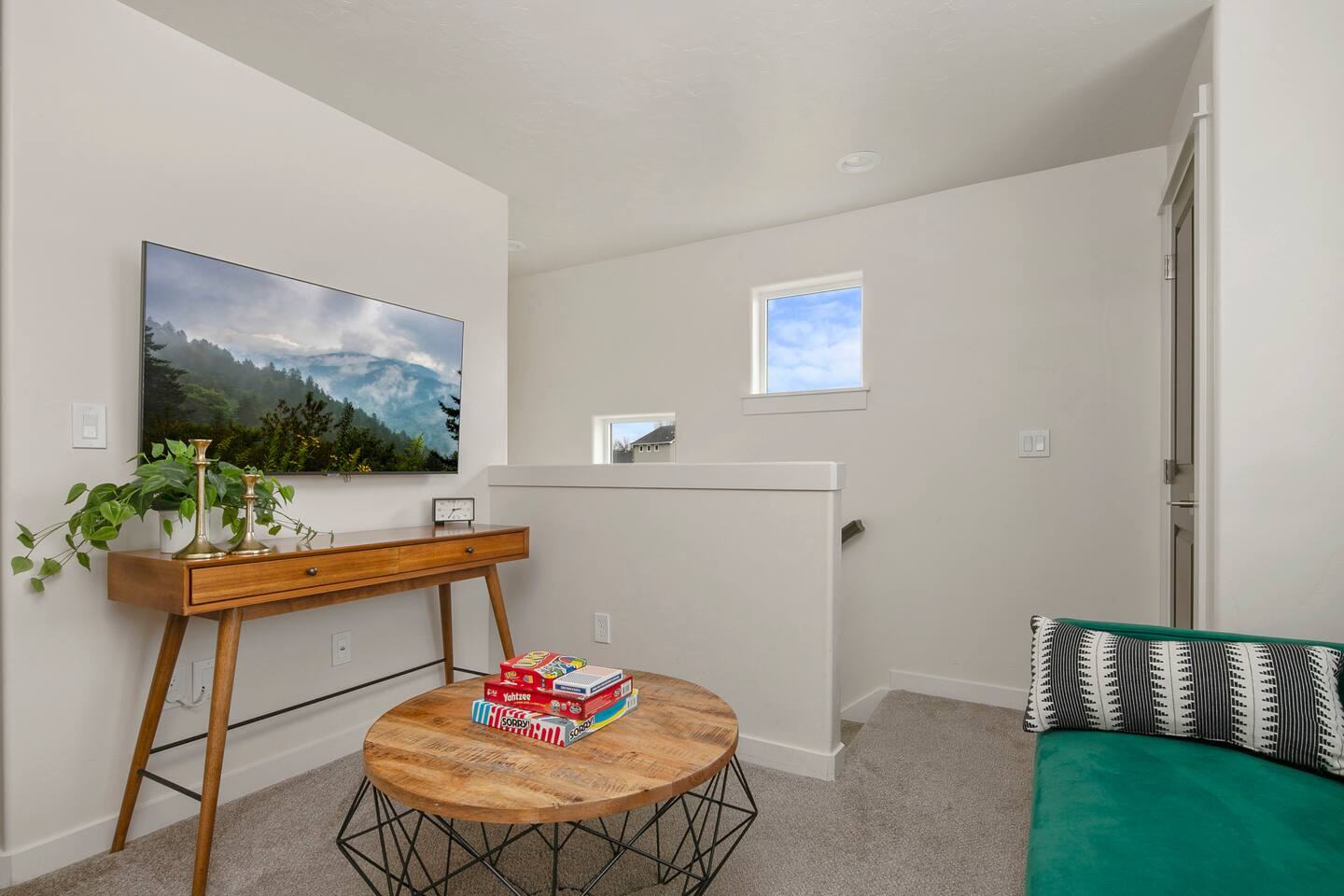 Upstairs TV lounge with console table and window seat