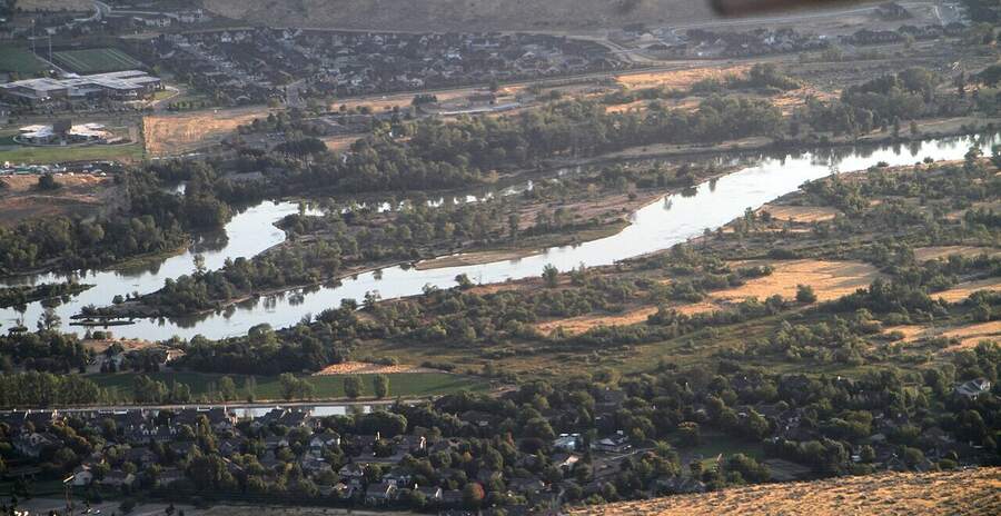 The Boise River winding through green trees and neighborhoods