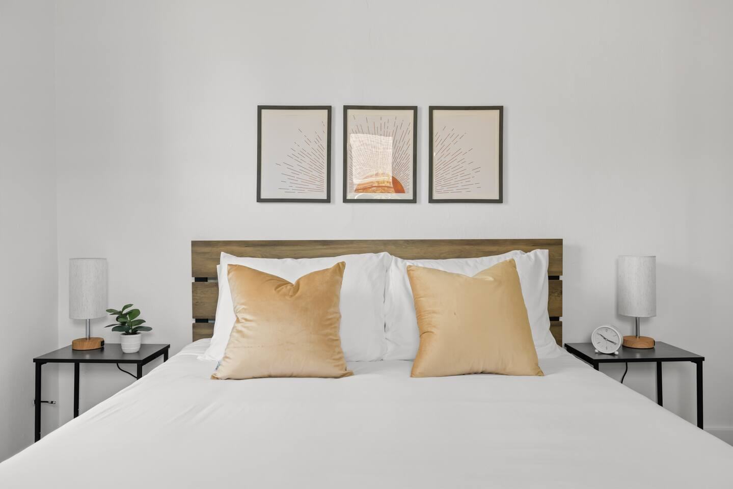 Bedroom with wood headboard and gold pillows