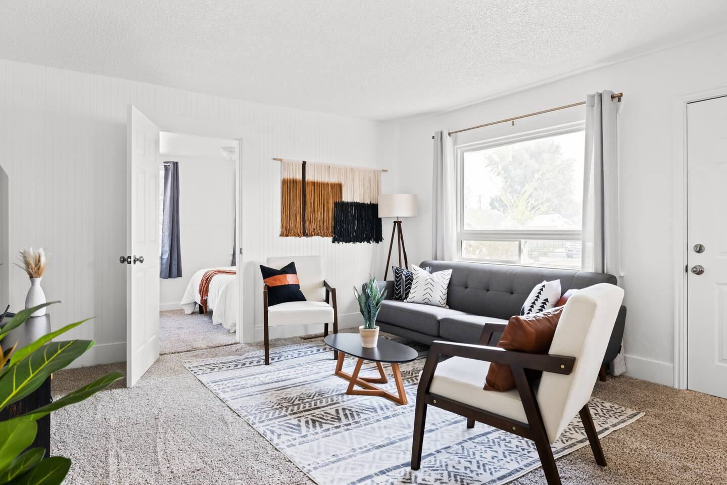 Bright living room with gray sofa and accent chairs