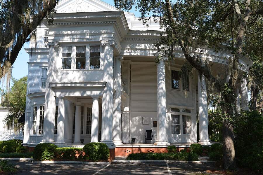 The white-columned Crescent mansion in Valdosta, Georgia, framed by live oaks