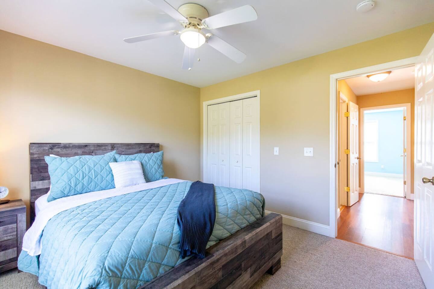Second bedroom with queen bed and blue quilt