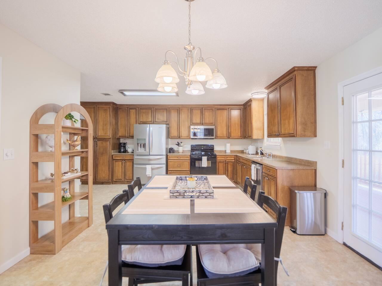Kitchen with honey wood cabinets and pub-height dining table