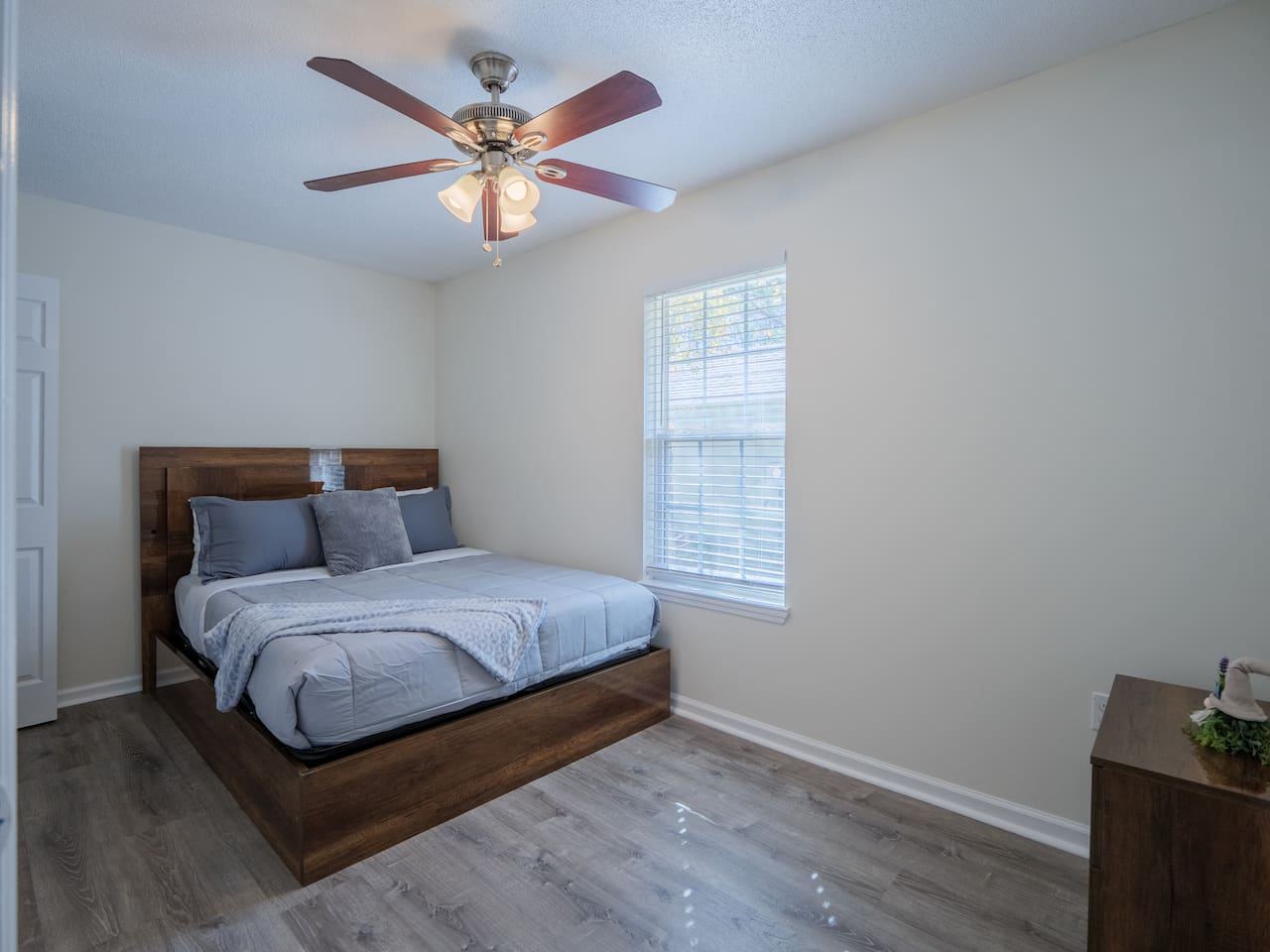 Third bedroom with queen bed and wood frame