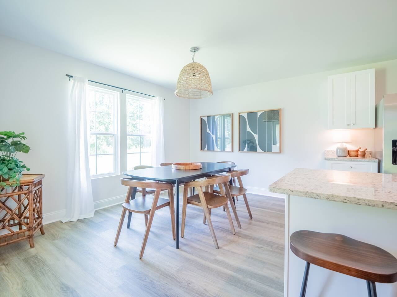 Dining area with woven pendant light and natural light