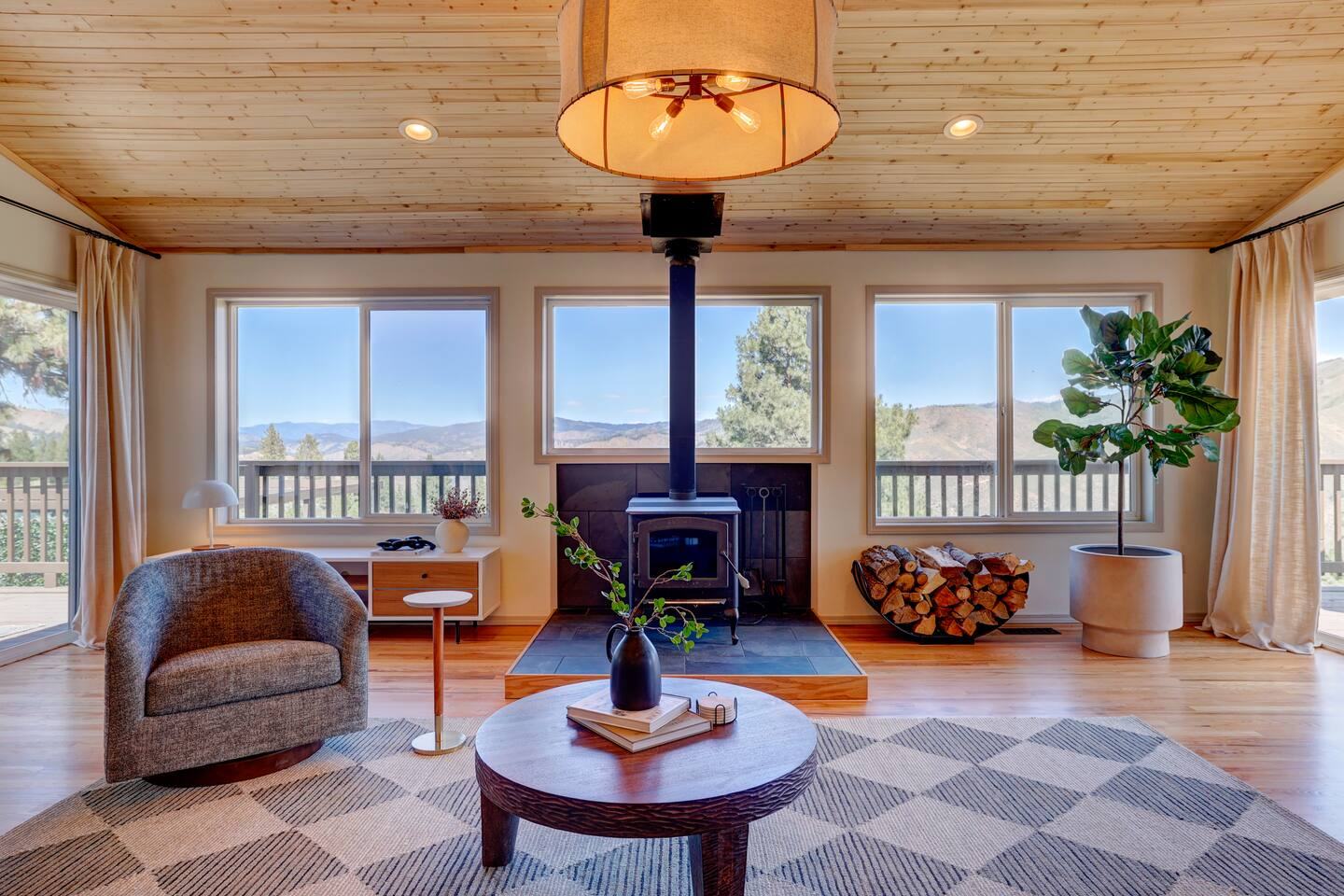Living room sitting area with fireplace and big windows
